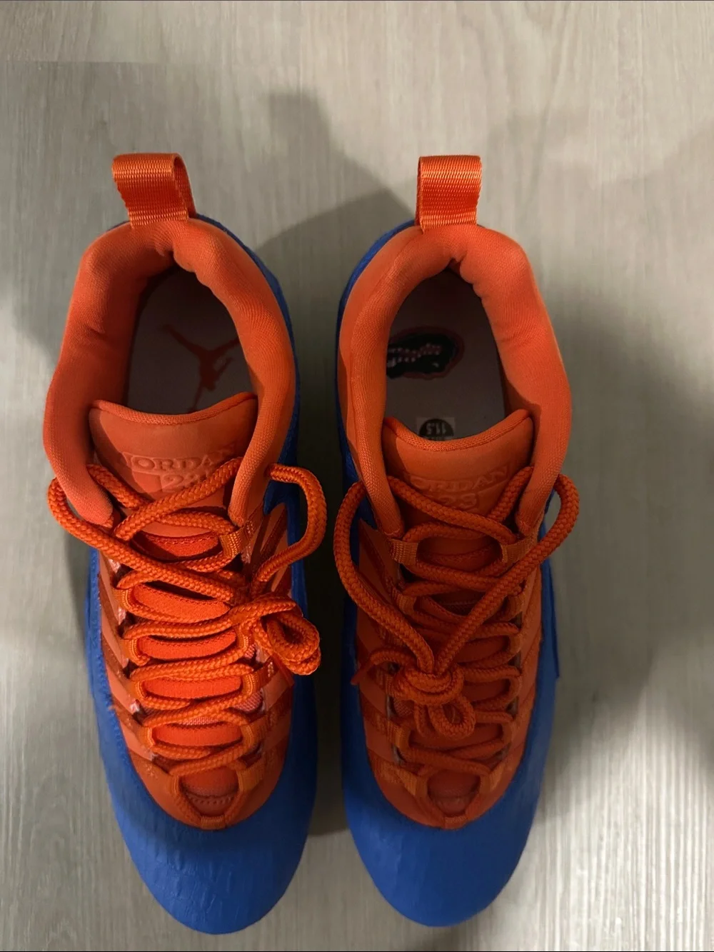 Custom Florida Air Jordan Cleats in Orange and Blue.